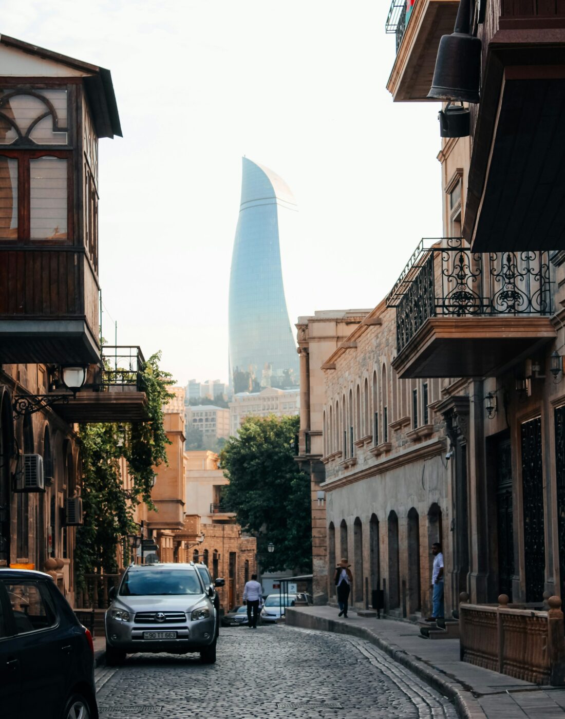 An old street in central Baku with the Flame Towers rising behind it
